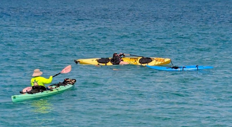Carolyn getting back on her kayak