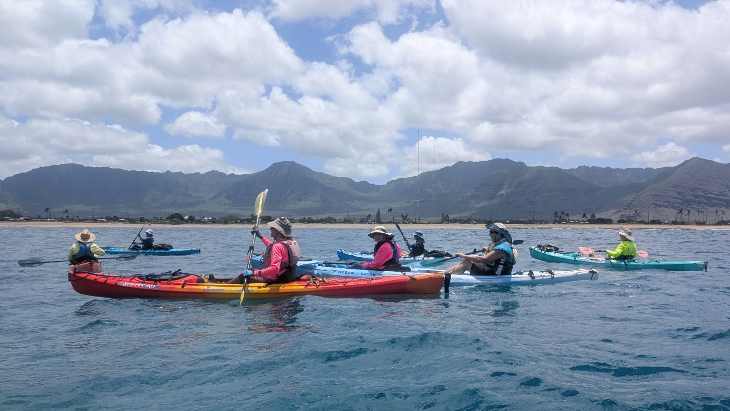 Six kayaks in a close group off of Maʻili Beach