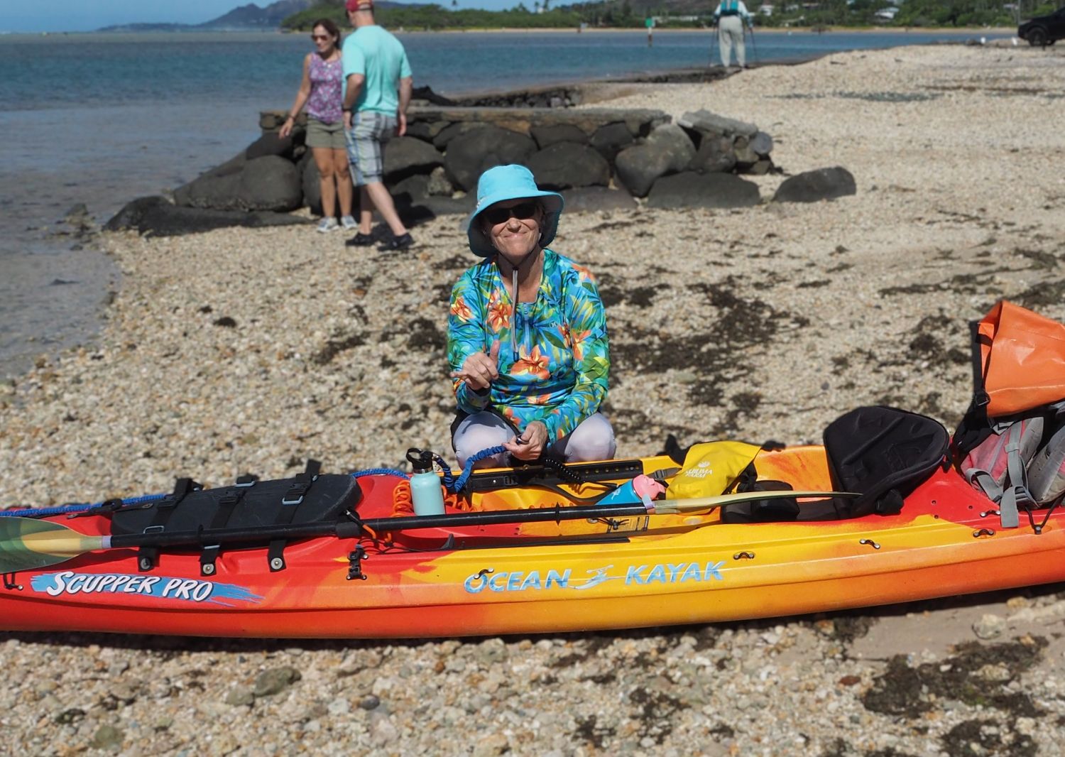 Sandy flashes the shaka next to her kayak