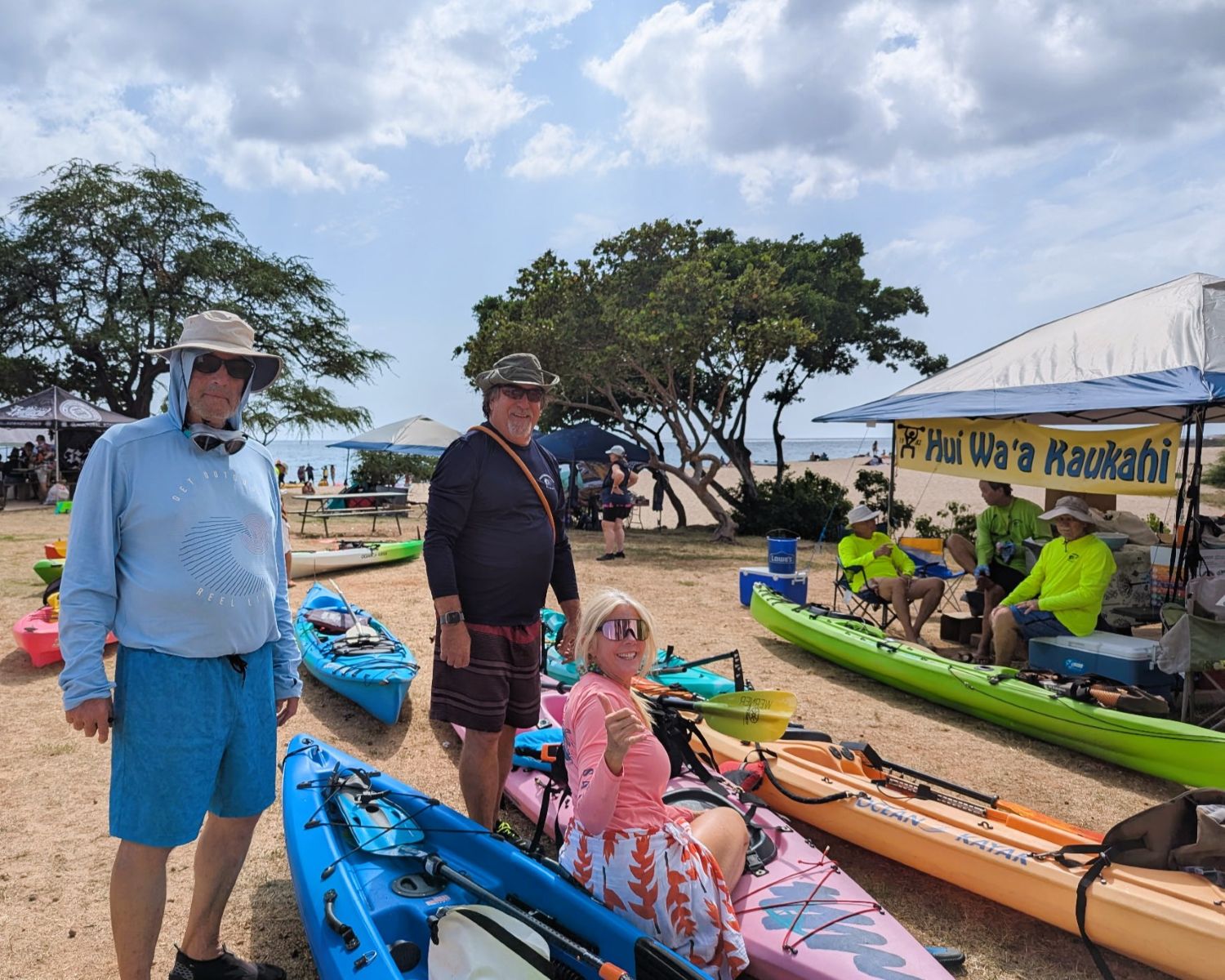 Two men and one woman at the kayak staging area