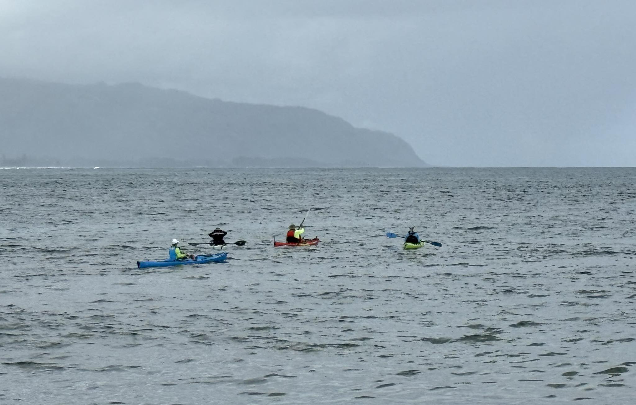 Four kayaks approaching rainy weather