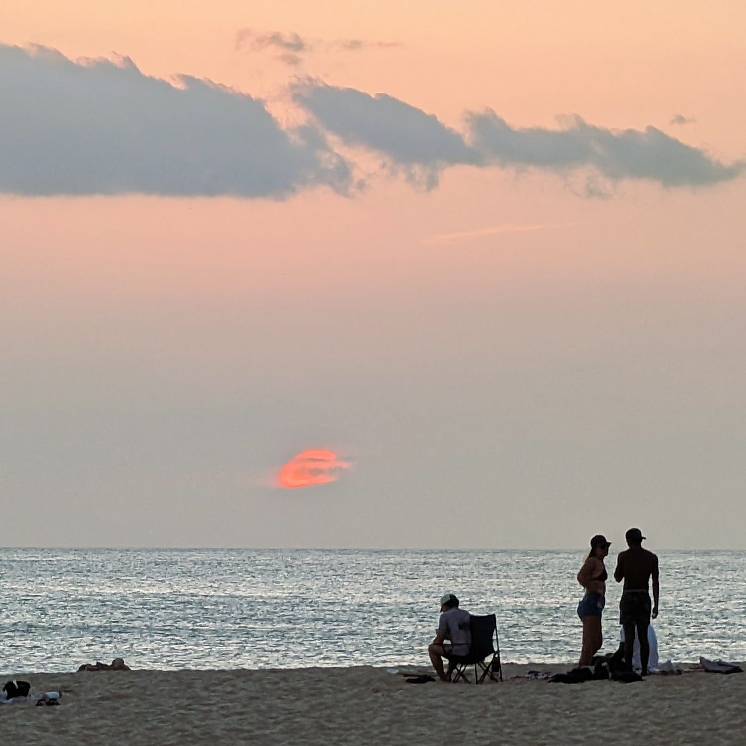 Setting sun disappears behind clouds