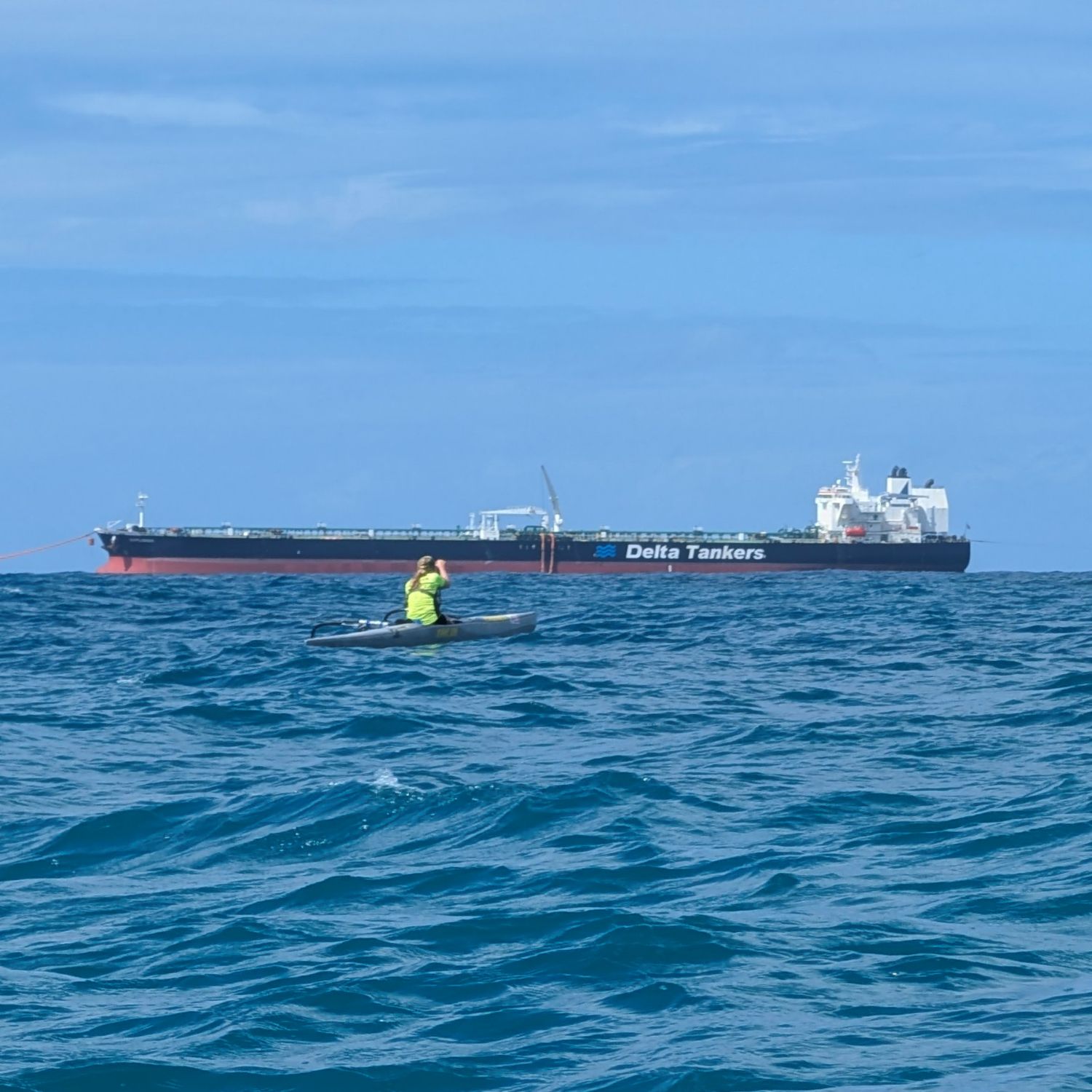 OC1 paddler with an oil tanker on the horizon