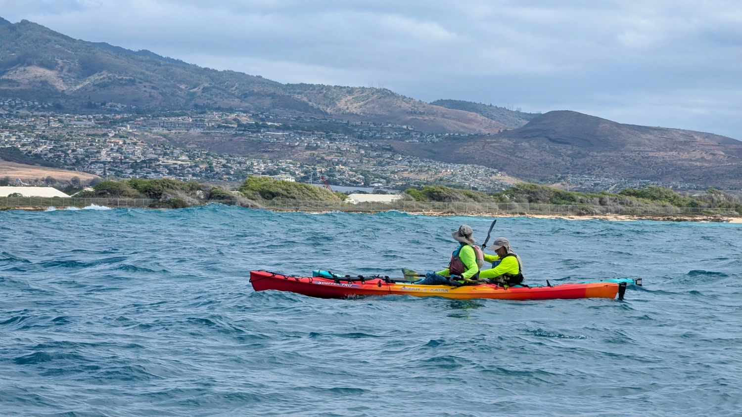 Two kayakers off of Nimitz Beach with Makakilo in the background