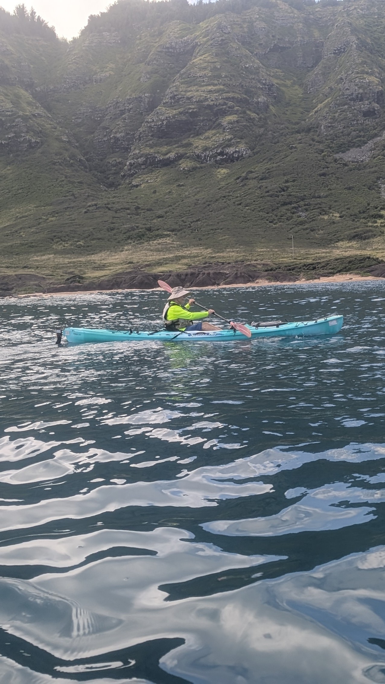 Solo kayaker at Kaena Pt