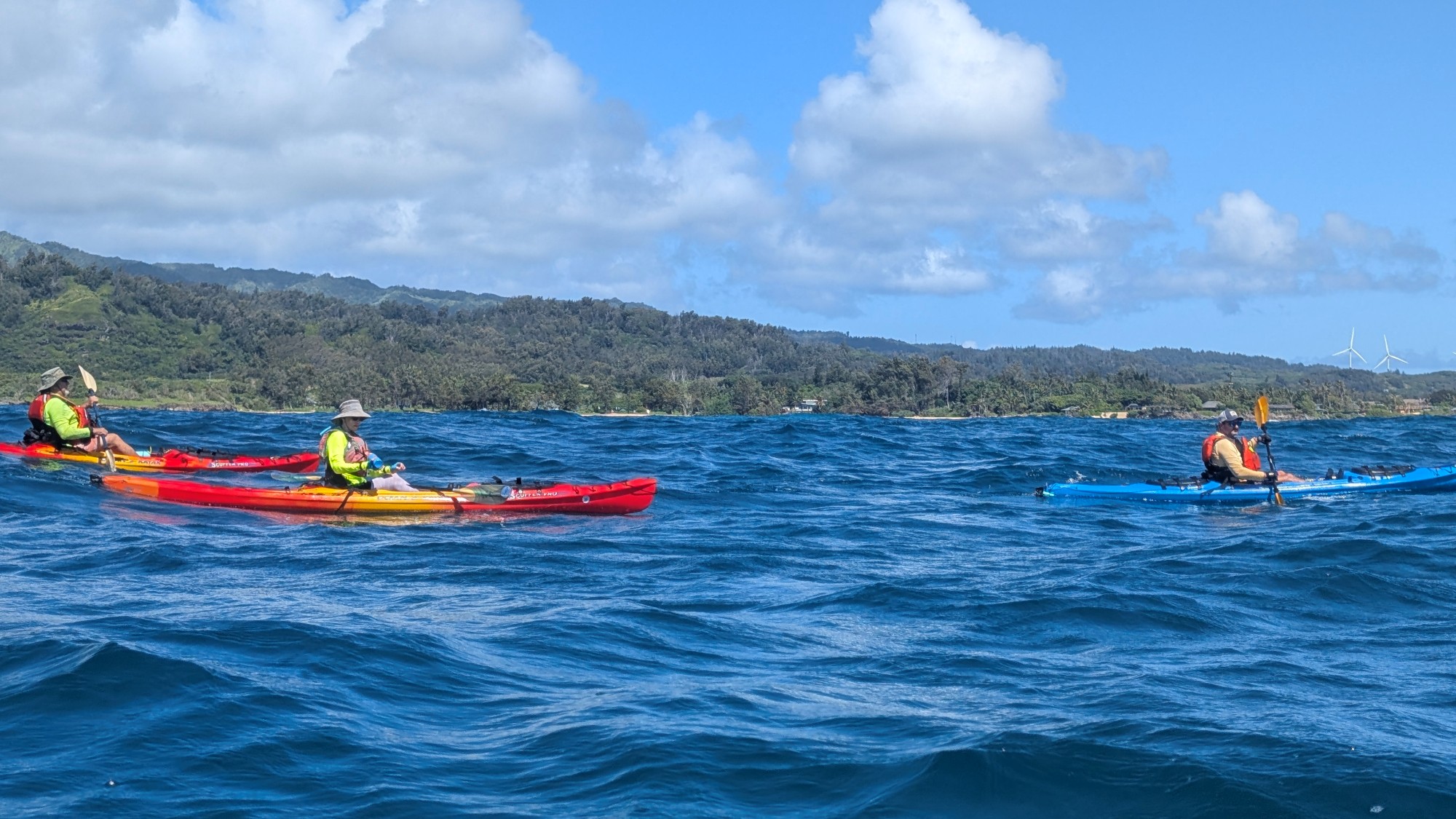 Three kayakers off of Laie