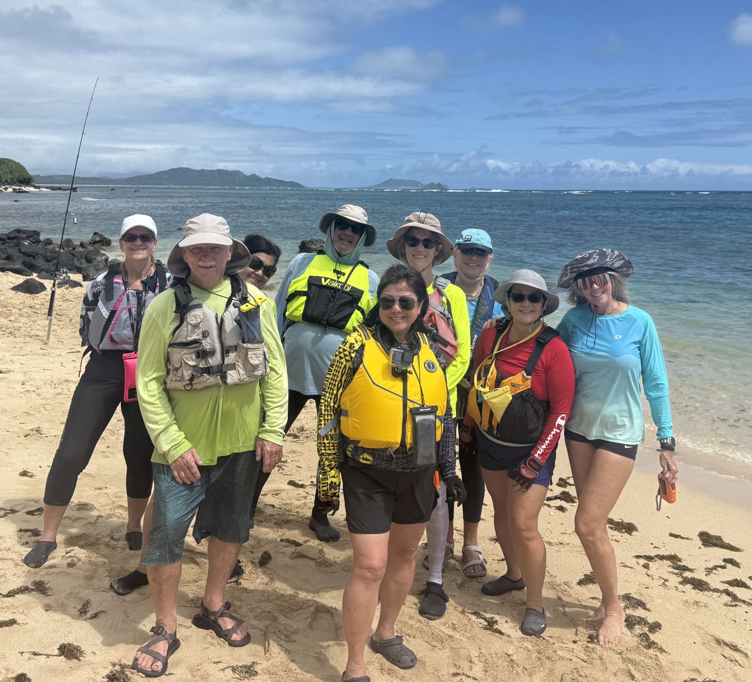 Group of kayakers on the beach with the Koolaus and Mokuluas in the background