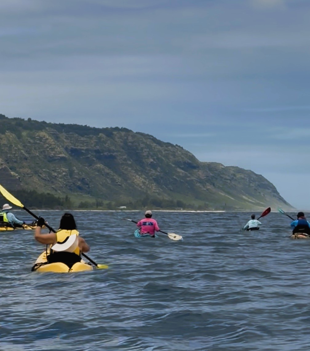 Group of kayakers paddling toward Mokuleia