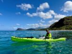 Kayaker with Maʻili Pt on the horizon