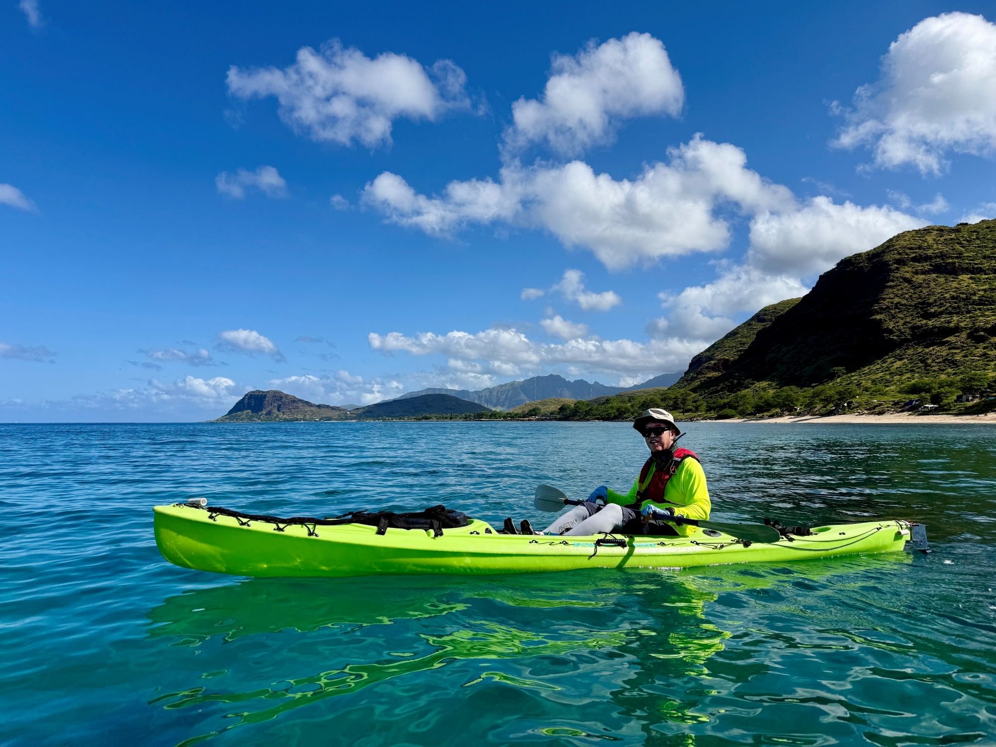Kayaker with Maʻili Pt on the horizon