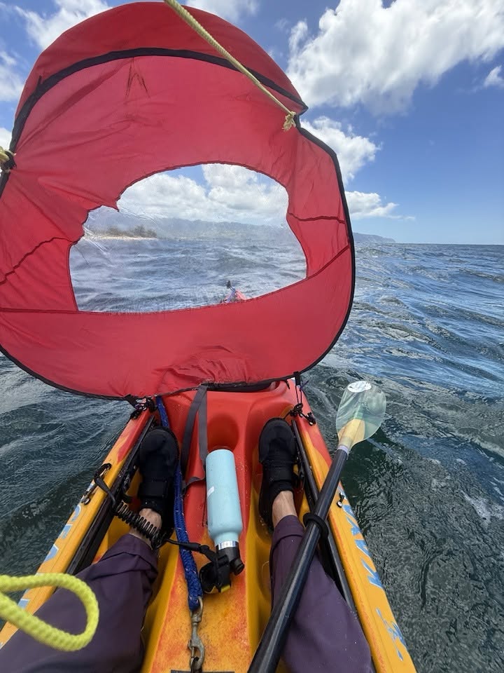 Looking through the viewport of a red kayak pop-up sail