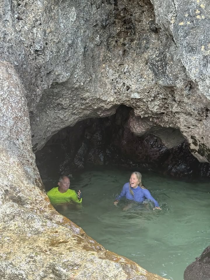 Man and woman in the water in the cavern under the jumping rock