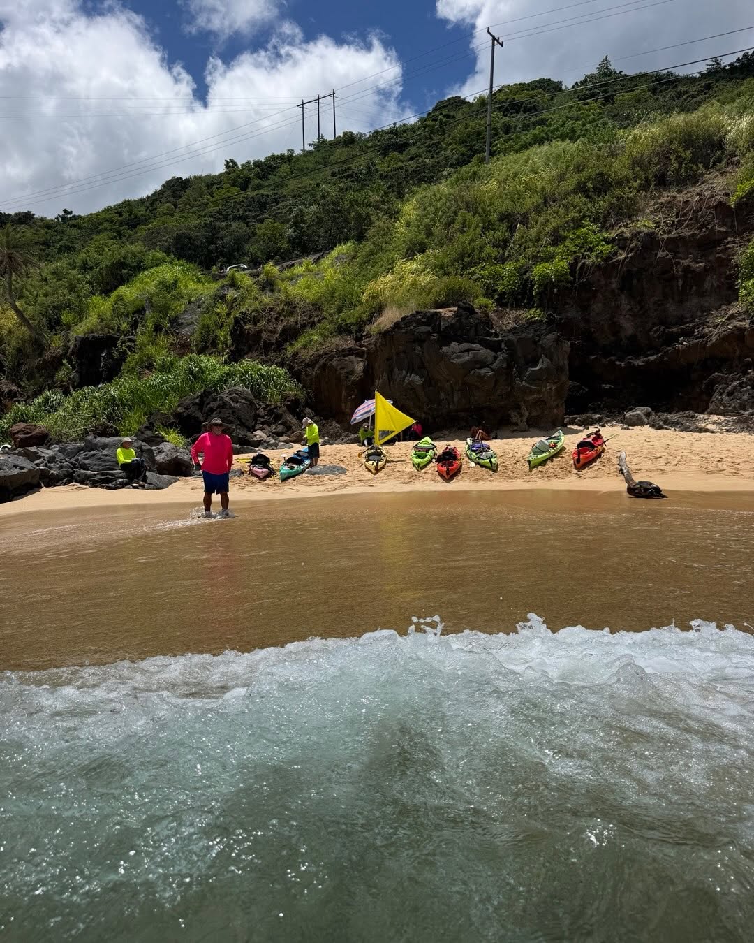 Eight kayaks on the beach at Waimea Bay