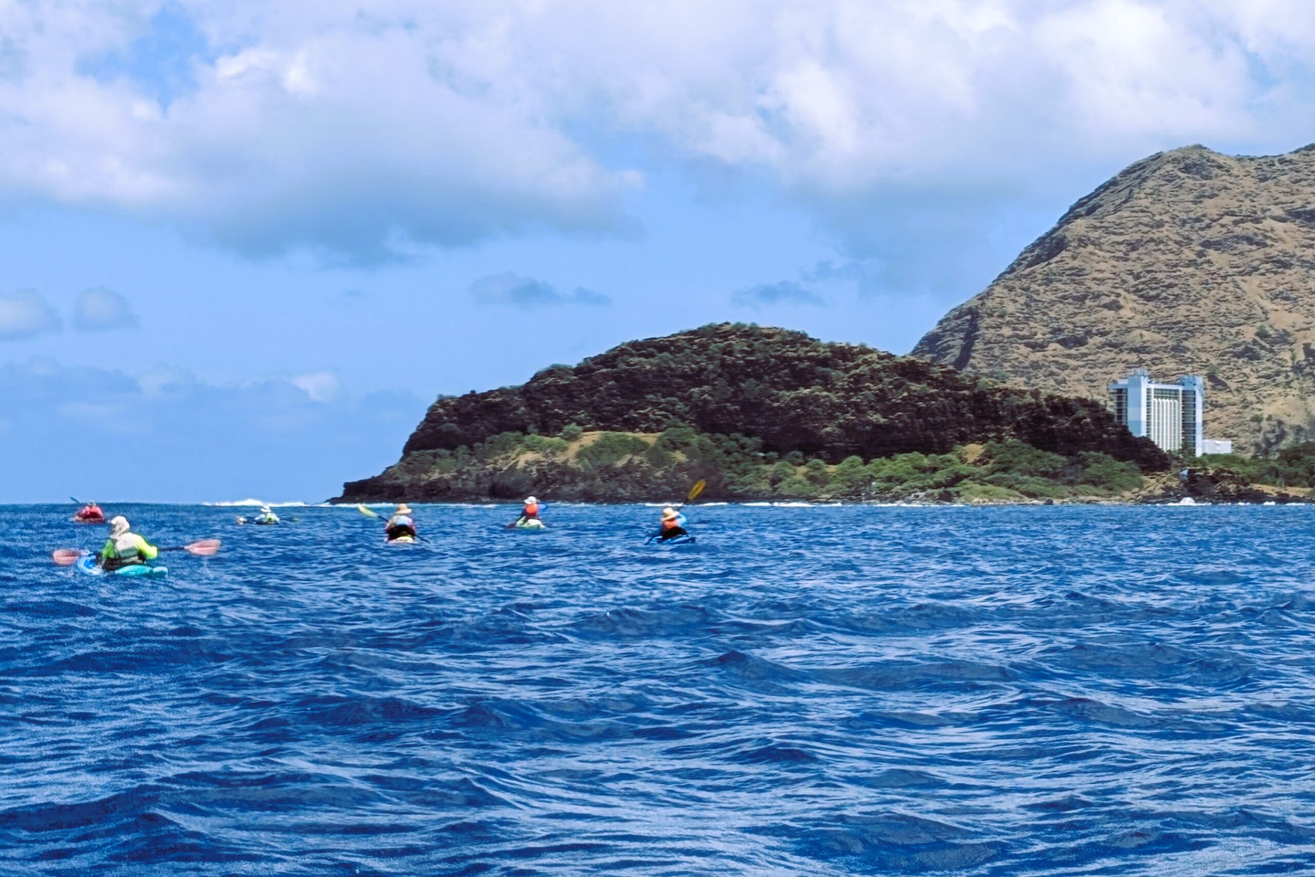 Six kayakers paddling toward Lahilahi